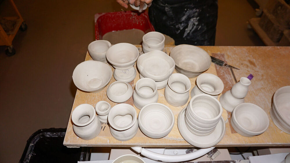 A board of freshly made bowls and cups