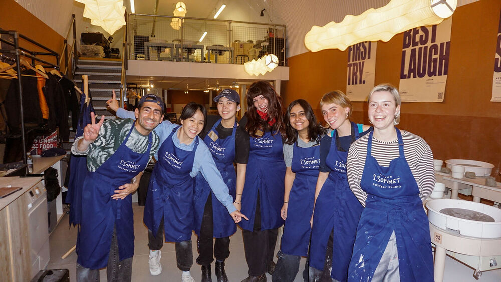 The studio team lined up in matching navy aprons